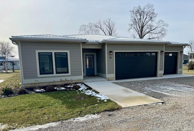 view of front facade with a garage and a front lawn