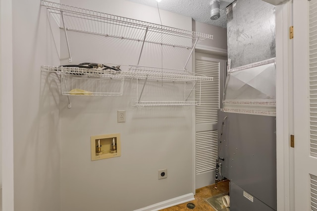 clothes washing area with washer hookup, hookup for an electric dryer, and a textured ceiling