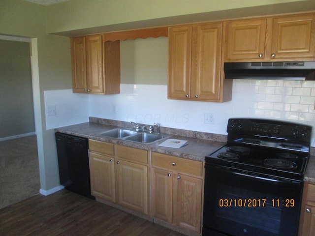 kitchen with dark hardwood / wood-style floors, light brown cabinetry, sink, and black appliances