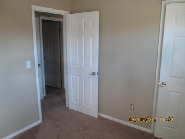 unfurnished bedroom with light colored carpet