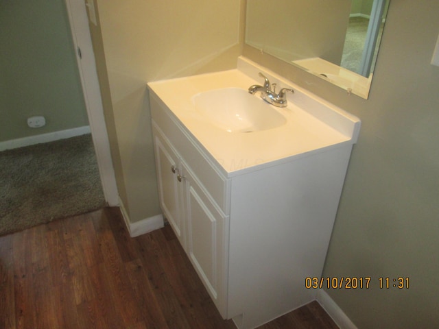 bathroom featuring vanity and wood-type flooring