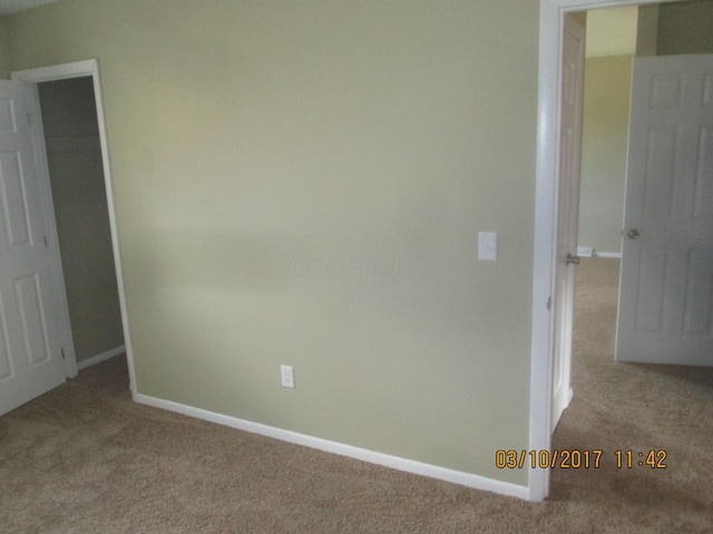 empty room with light colored carpet