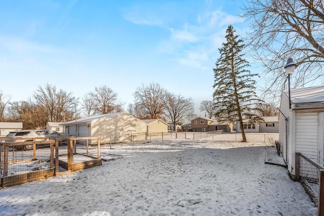 yard covered in snow featuring a garage