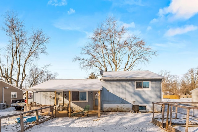 snow covered back of property with cooling unit