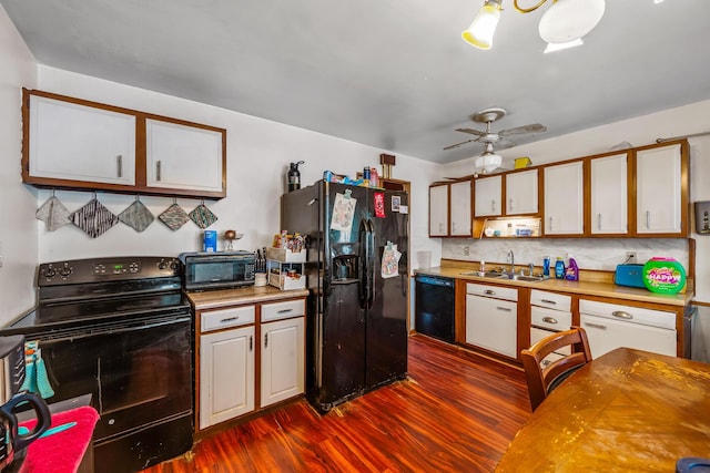 kitchen with sink, black appliances, dark hardwood / wood-style floors, ceiling fan, and white cabinets