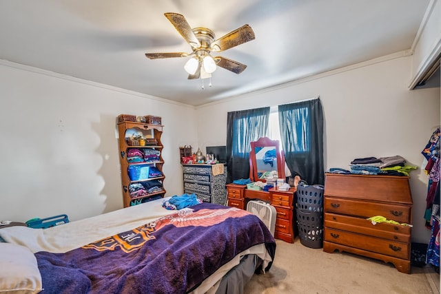 carpeted bedroom with crown molding and ceiling fan