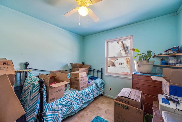 carpeted bedroom with ceiling fan and ornamental molding