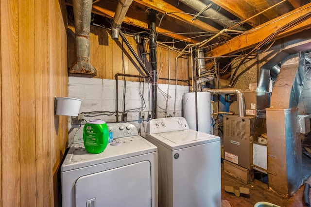 laundry area featuring heating unit, gas water heater, and washing machine and dryer