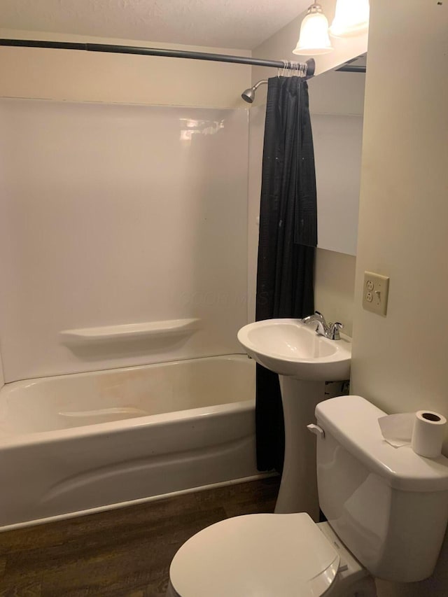 full bathroom with shower / bath combination with curtain, wood-type flooring, toilet, and sink