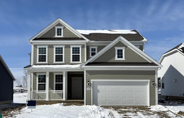 view of front of home featuring covered porch and a garage