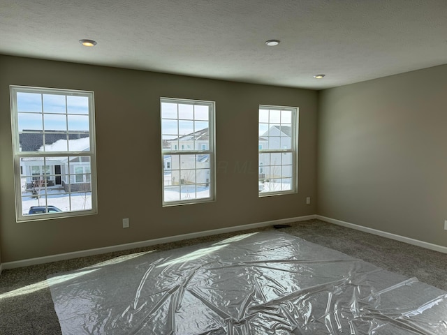 spare room with a textured ceiling