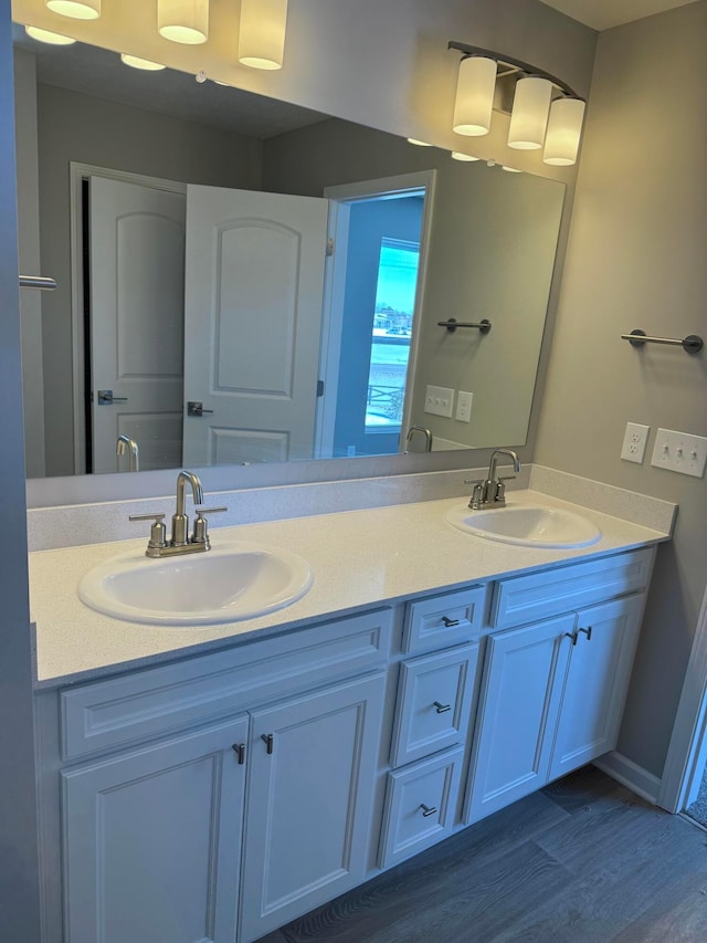 bathroom with hardwood / wood-style flooring and vanity