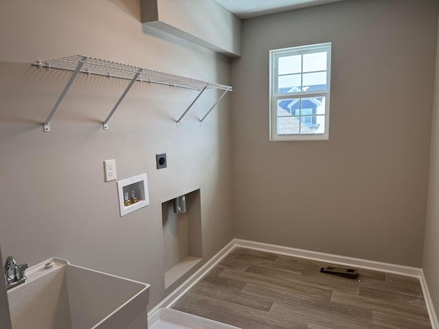 laundry room with hardwood / wood-style flooring, sink, washer hookup, and electric dryer hookup