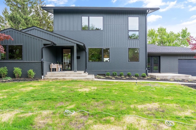 modern inspired farmhouse featuring a front lawn