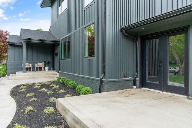 view of property exterior featuring board and batten siding and a patio