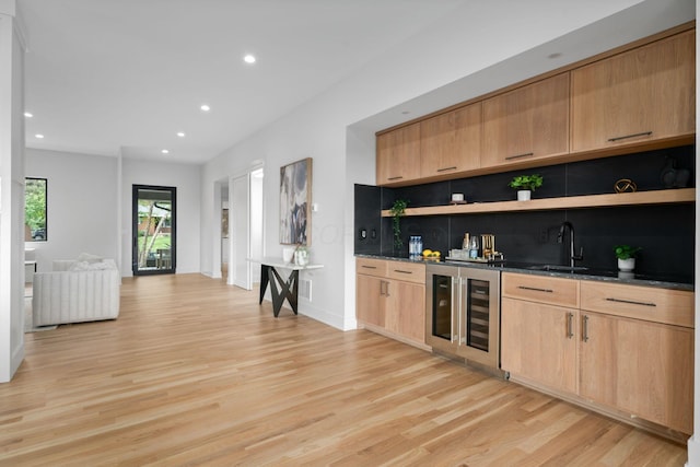 bar featuring a sink, recessed lighting, light wood-type flooring, wet bar, and wine cooler