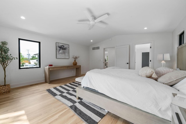 bedroom featuring light wood finished floors, visible vents, vaulted ceiling, and recessed lighting