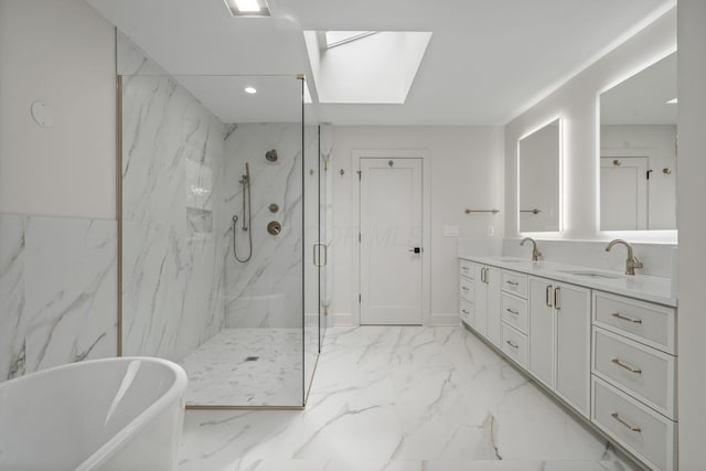 full bath featuring a marble finish shower, a sink, a skylight, a freestanding tub, and marble finish floor