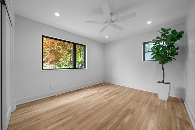 empty room featuring light wood finished floors, baseboards, a ceiling fan, and recessed lighting