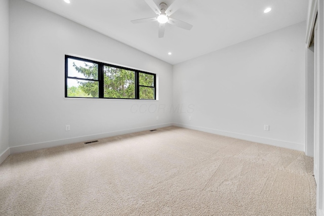unfurnished room with baseboards, recessed lighting, light carpet, and visible vents