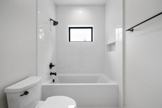 bathroom featuring shower / bathing tub combination and toilet
