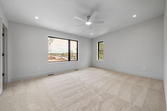 carpeted spare room featuring ceiling fan, baseboards, visible vents, and recessed lighting