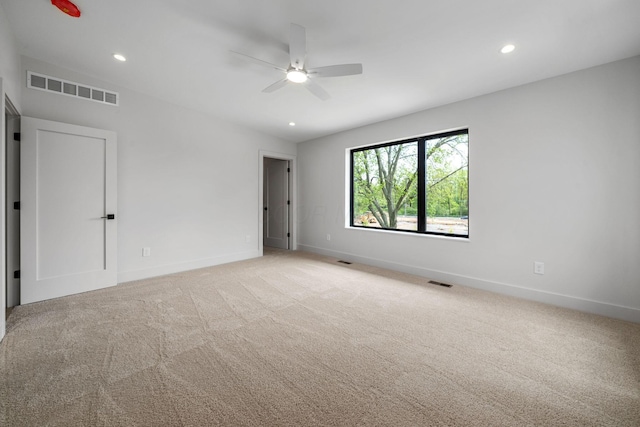 unfurnished room with visible vents, baseboards, ceiling fan, and light carpet
