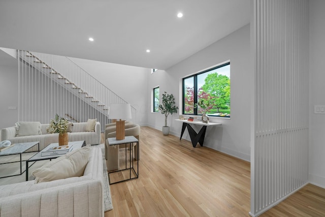 living room with light wood finished floors, baseboards, and recessed lighting