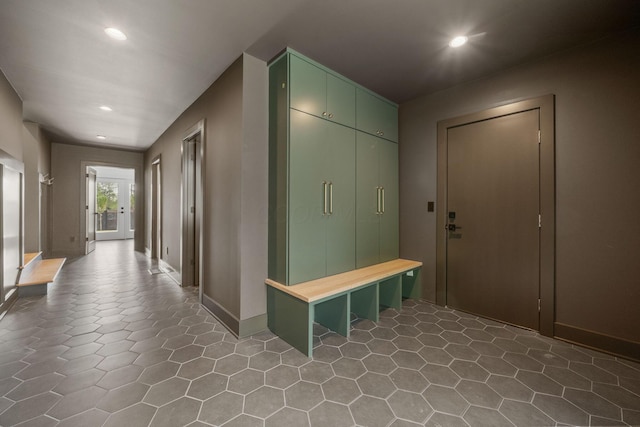interior space with baseboards, tile patterned flooring, and recessed lighting