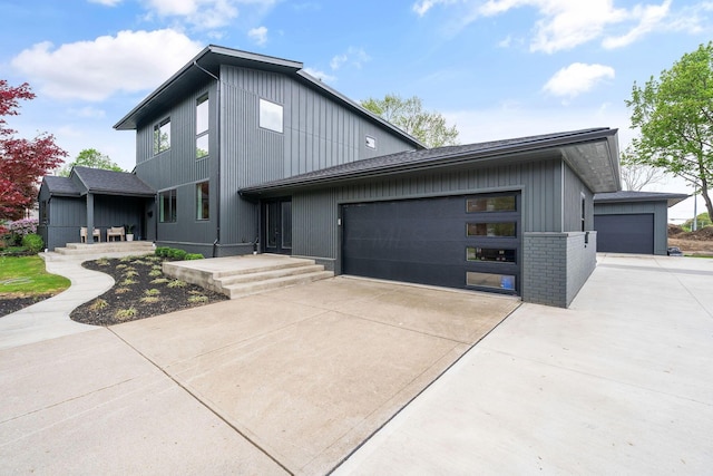 view of front of house with concrete driveway, an attached garage, and brick siding