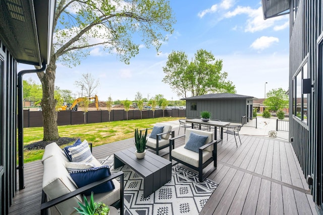 deck with a fenced backyard, a lawn, outdoor dining space, and an outdoor living space