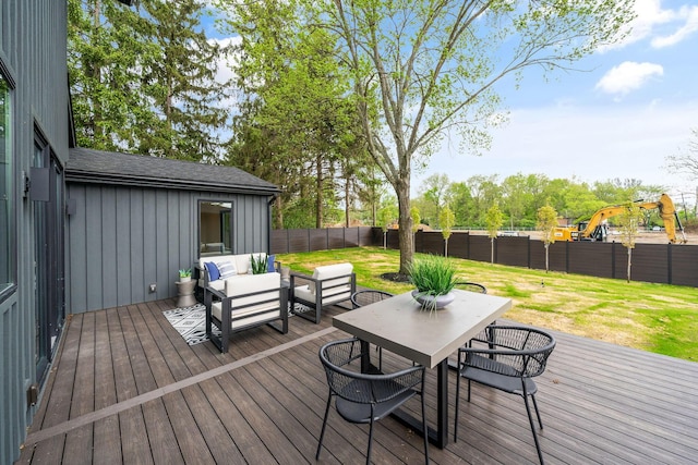 deck with a yard, outdoor dining area, a fenced backyard, and an outdoor living space