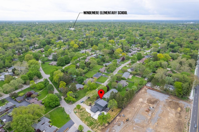birds eye view of property featuring a view of trees