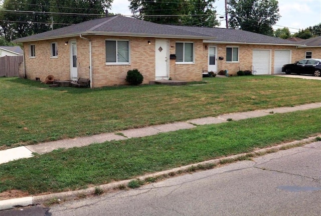 ranch-style home with a garage and a front yard