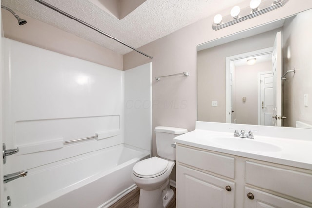 full bathroom featuring shower / bath combination, vanity, hardwood / wood-style flooring, toilet, and a textured ceiling