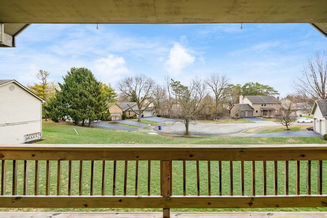 wooden deck with a lawn