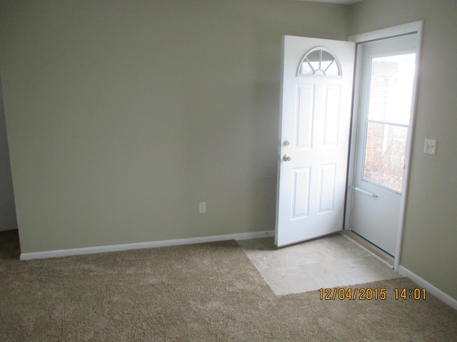 view of carpeted foyer entrance