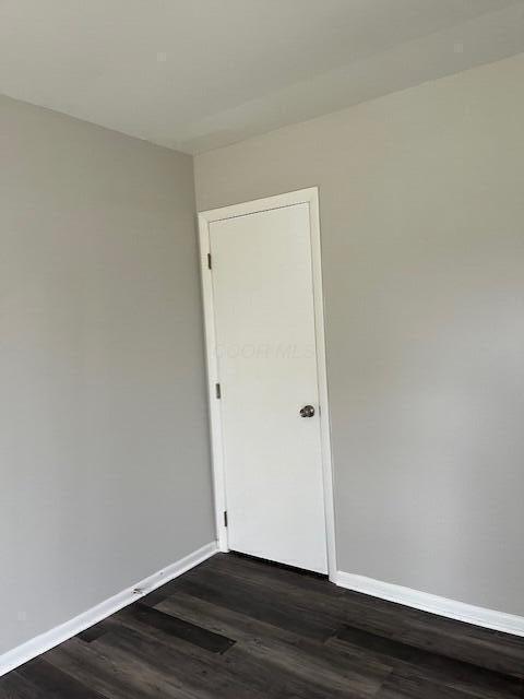 spare room with dark hardwood / wood-style floors