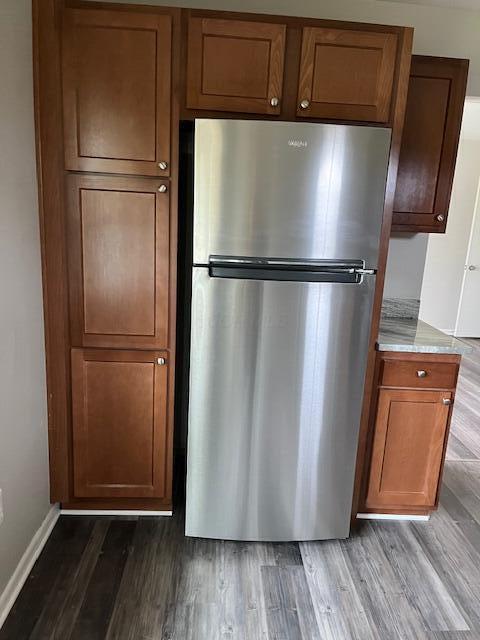 kitchen with stainless steel fridge and light hardwood / wood-style flooring