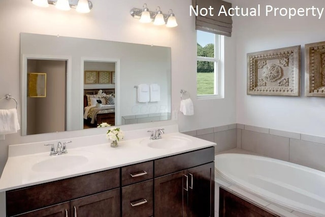 bathroom with a relaxing tiled tub and vanity