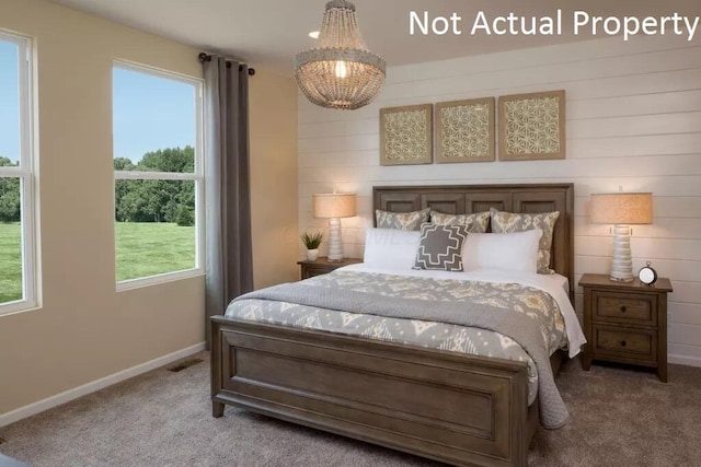 bedroom featuring multiple windows, carpet flooring, and baseboards