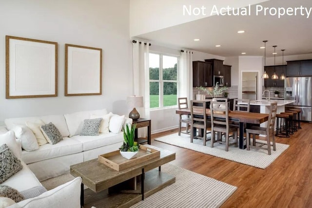 living area featuring recessed lighting and light wood-type flooring