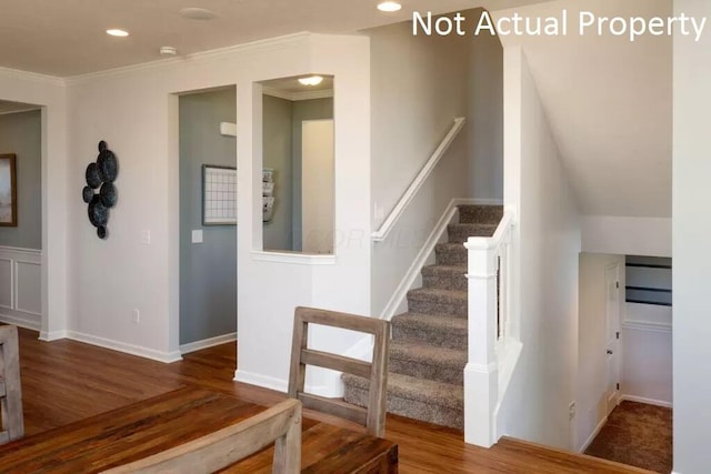 stairs featuring ornamental molding and hardwood / wood-style floors