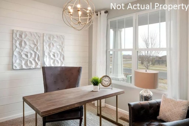 office with a healthy amount of sunlight, a notable chandelier, and wooden walls