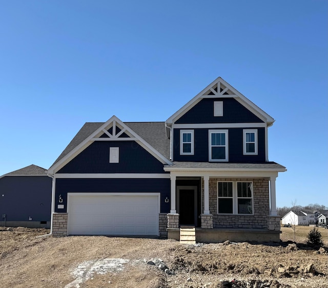 craftsman house with a garage, stone siding, a porch, and dirt driveway