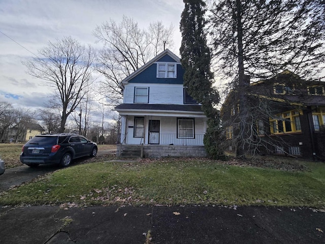 view of front of home featuring a front yard and covered porch