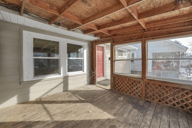 unfurnished sunroom featuring a wooden deck