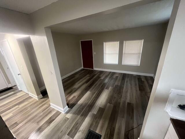 unfurnished room with dark hardwood / wood-style flooring