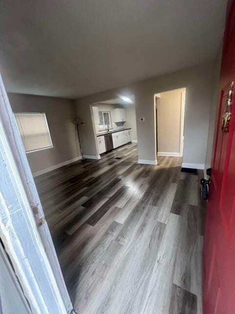 unfurnished living room with dark wood-type flooring