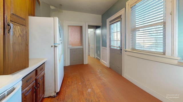 kitchen with light wood-type flooring and white fridge